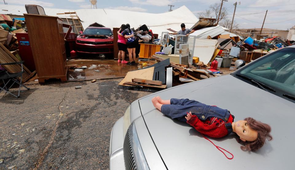 A doll salvaged from a storm-damaged mini-warehouse at Second Street and Avenue G sits on the hood of a car Wednesday afternoon in Levelland.  Parts of Levelland were severely damaged by Wednesday's storms.