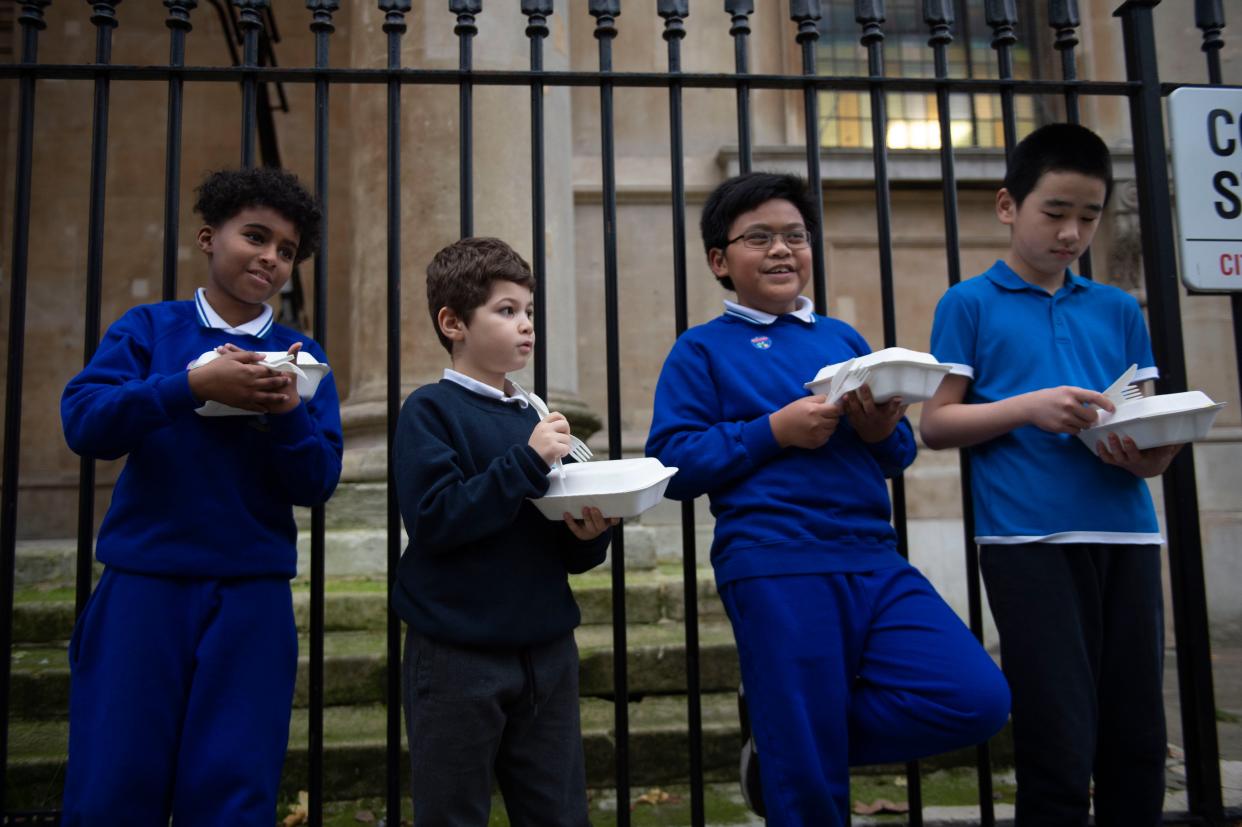 <p>Food for now: children with their Felix takeaways in central London. Experts warn today that hunger can leave children with stress, problems with concentration and anxiety</p> (Lucy Young)