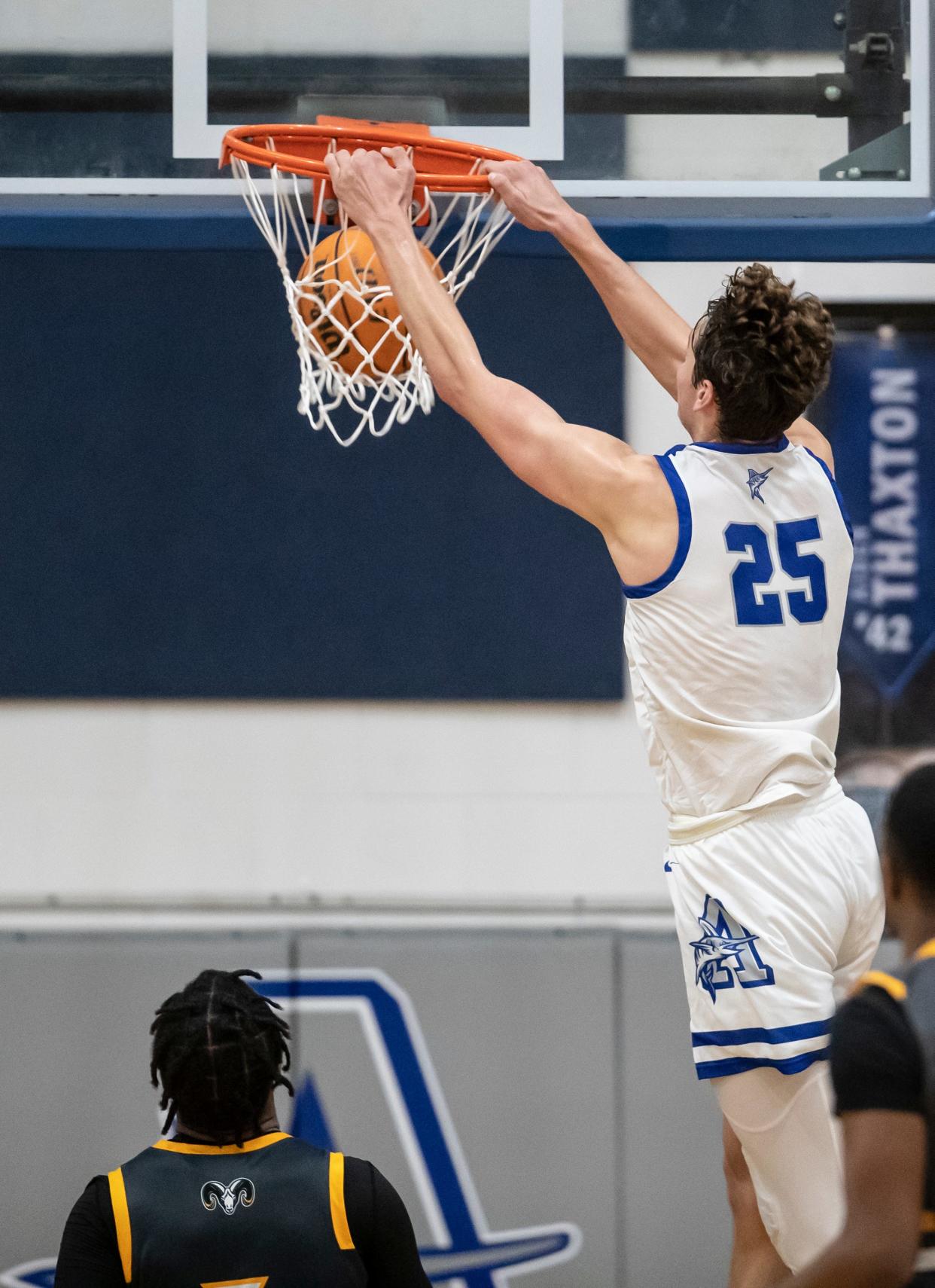 Arnold senior Alex Steen hangs on the rim with a big dunk in the second half. Arnold hosted Rutherford in boys basketball Tuesday, January 25, 2022. 