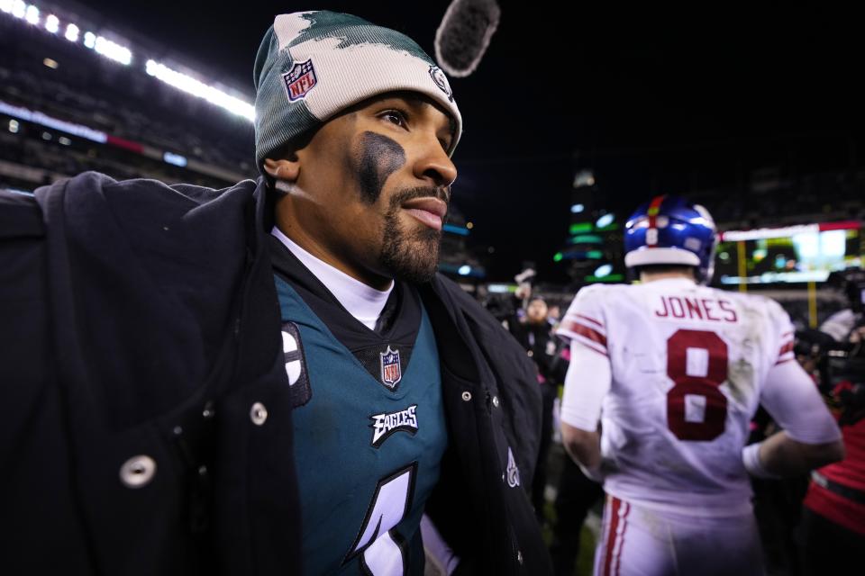 Philadelphia Eagles quarterback Jalen Hurts, left, looks on after talking with New York Giants quarterback Daniel Jones (8) following an NFL divisional round playoff football game, Saturday, Jan. 21, 2023, in Philadelphia. The Eagles won 38-7. (AP Photo/Matt Slocum)