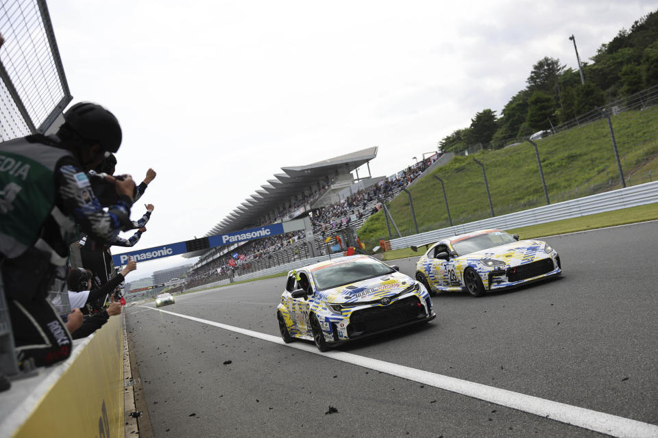 In this photo released by Toyota Motor Corp., Toyota’s Corolla racing car, front left, powered by liquid hydrogen runs on the racing course during a 24-hour race at Fuji International Speedway in Oyama town, some 100 kilometers (62 miles) southwest of Tokyo, Sunday, May 28, 2023. The hydrogen-fueled Corolla has made its racing debut, part of a move to bring the futuristic technology into the racing world and to demonstrate Toyota’s resolve to develop green vehicles. (Toyota Motor Corp. via AP)