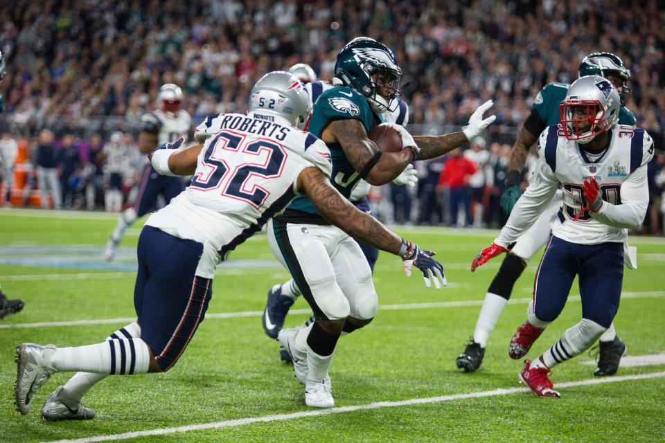 Eagles running back Corey Clement looks for a way through the Patriots defense Sunday at US Bank Stadium.