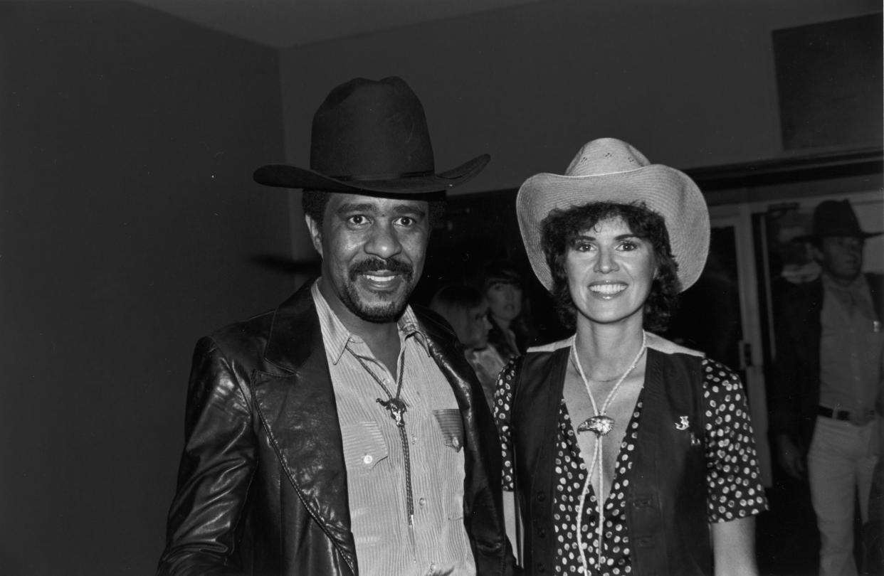 19th May 1979:  American comedian and actor Richard Pryor and his future wife, Jennifer Lee, wearing cowboy hats and bolo ties, smile while at the annual SHARE party, held at the Hollywood Palladium, Hollywood, California.  (Photo by Bob V. Noble/Fotos International/Getty Images)