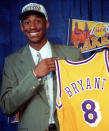 FILE - In this July 12, 1996 file photo Kobe Bryant, 17, jokes with the media as he holds his Los Angeles Lakers jersey during a news conference at the Great Western Forum in Inglewood, Calif. Bryant, a five-time NBA champion and a two-time Olympic gold medalist, died in a helicopter crash in California on Sunday, Jan. 26, 2020. He was 41. (AP Photo/Susan Sterner, file)