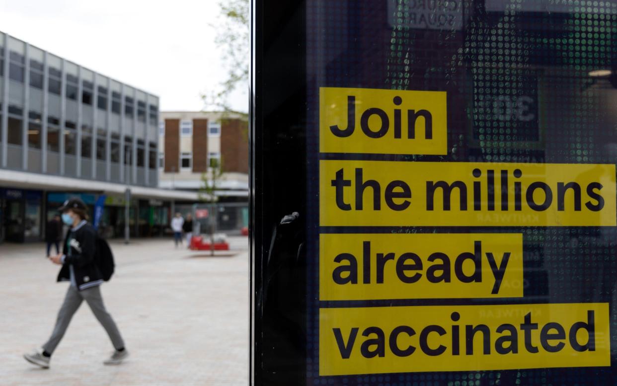 A poster in Bedford urges more people to join the ranks of the vaccinated - Jason Alden/Bloomberg