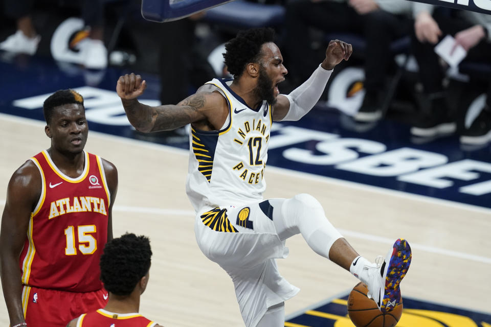 Indiana Pacers' Oshae Brissett (12) reacts after a dunk during the second half of the team's NBA basketball game against the Atlanta Hawks, Thursday, May 6, 2021, in Indianapolis. (AP Photo/Darron Cummings)