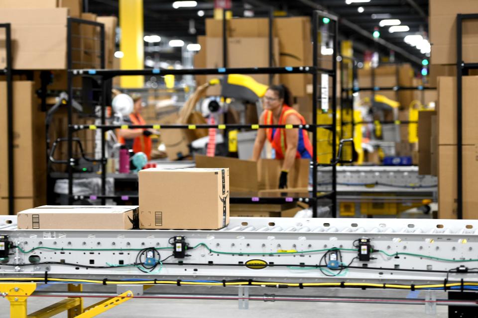 Boxes run along a belt during processing at Amazon Canton Fulfillment Center, AKR1.  Wednesday, August 09, 2023.
