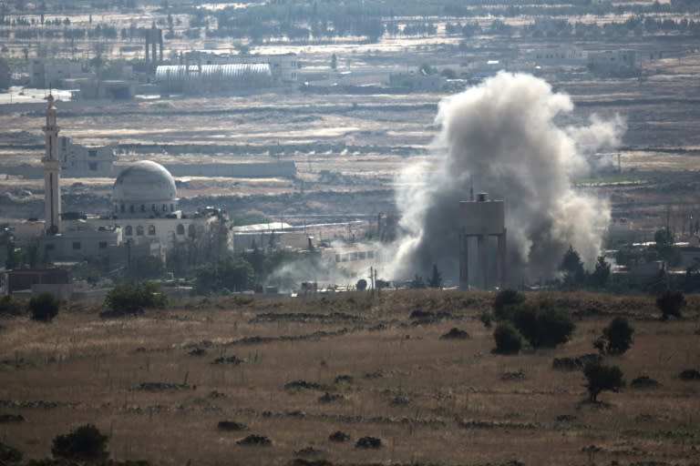 A view from the Golan Heights shows smoke rising following explosions in a village in Syria's Quneitra province, on June 17, 2015