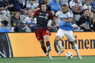 Toronto FC forward Federico Bernardeschi, left, and Charlotte FC defender Bill Tuiloma vie for the ball during the second half of an MLS soccer match in Charlotte, N.C., Saturday, April 13, 2024. (AP Photo/Nell Redmond)