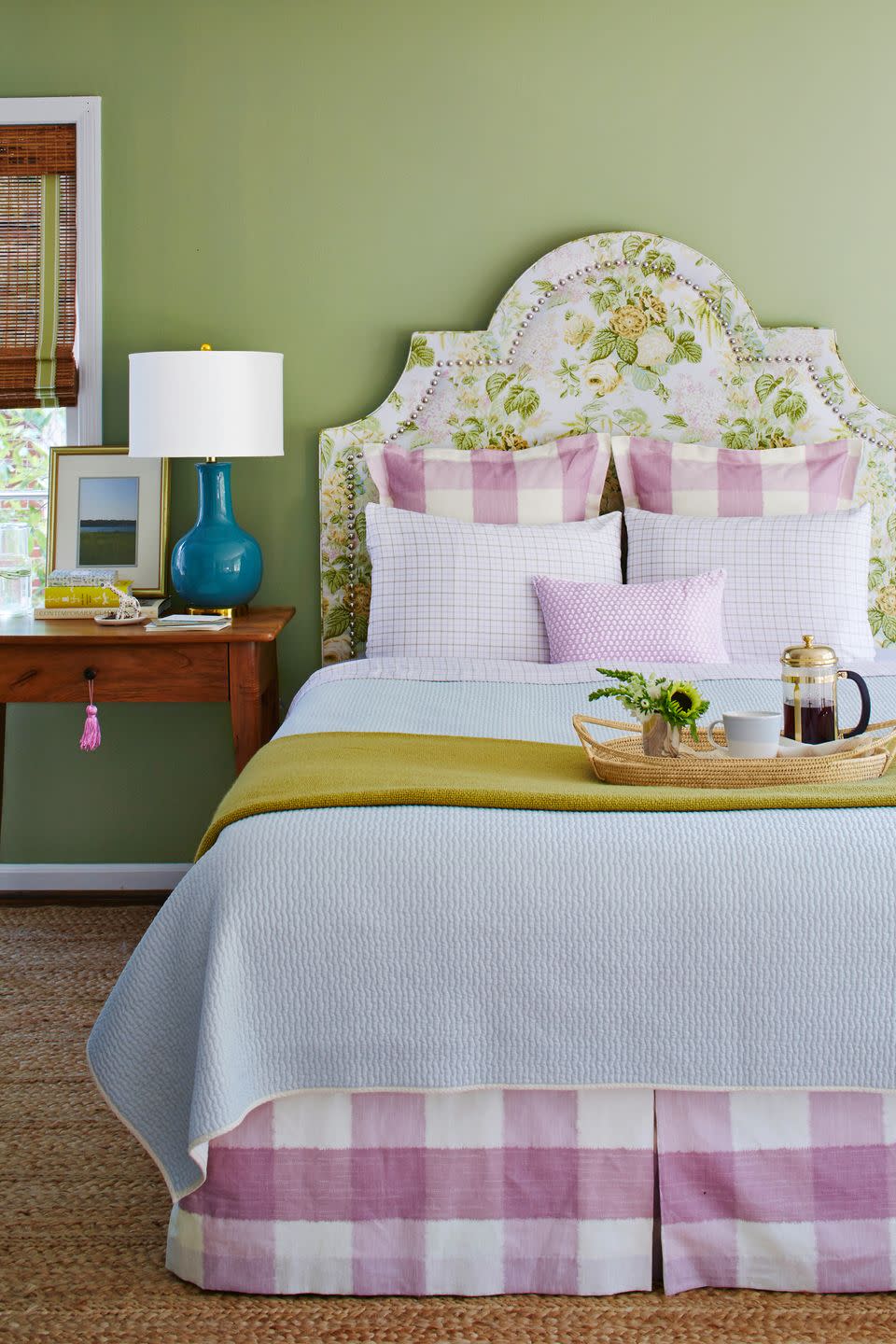bedroom with rose chintz headboard and lilac checked bedding