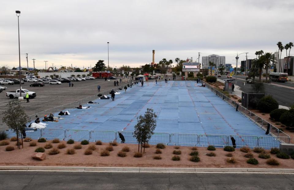 Blue mats were laid down for people to sleep on.