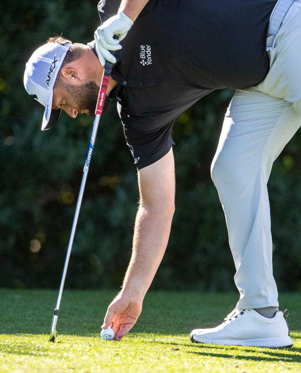 Jon Rahm places his ball in the third tee box during round one of The American Express golf tournament at La Quinta Country Club in La Quinta, Calif., Thursday, Jan. 19, 2023. 