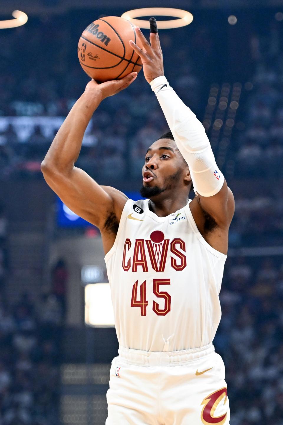 Cleveland Cavaliers' Donovan Mitchell shoots a 3-point basket against the New York Knicks during the first half of Game 1 in a first-round NBA basketball playoffs series Saturday, April 15, 2023, in Cleveland.