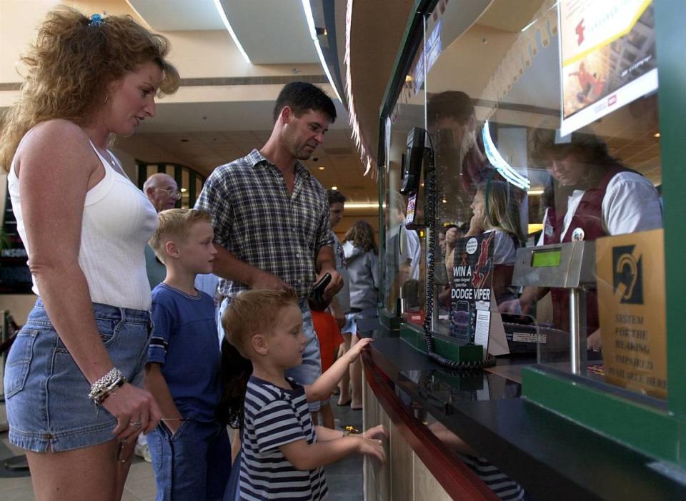 Ronni and Scott Sever purchase tickets for Spiderman with their children, Zane and Bailey at the Royal Palm 20 Theater in 2002.