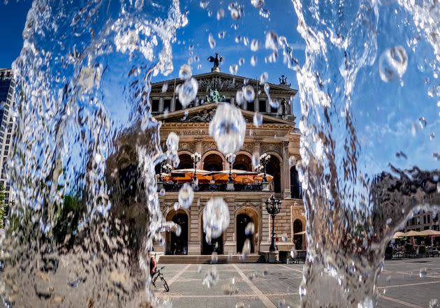 Water from a fountain runs down in front of the Old Opera in Frankfurt, Germany, on Monday. Germany expects high temperatures on Monday and Tuesday. (Photo: Michael Probst / AP)
