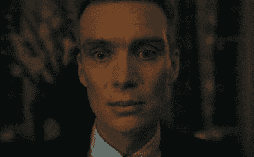 Cillian Murphy stares at an audience with widened eyes in "Oppenheimer"