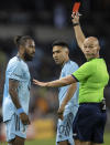 Minnesota United's Romain Metanire receives a red card for throwing the ball at Philadelphia Union's Kai Wagner (27) during the second half of an MLS soccer match Wednesday, Oct. 20, 2021, in St. Paul, Minn. (Carlos Gonzalez/Star Tribune via AP)