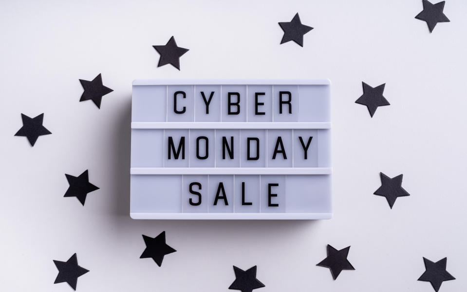 Cyber Mnday shopping concept. Cyber Monday Sale words on lightbox with confetti top view flat lay on white background