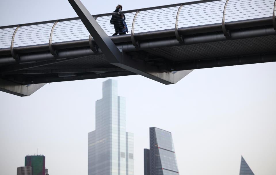 Services  The financial district can be seen as people walk across Millennium Bridge, amid the coronavirus disease (COVID-19) outbreak, in London, Britain, December 14, 2020. REUTERS/Henry Nicholls