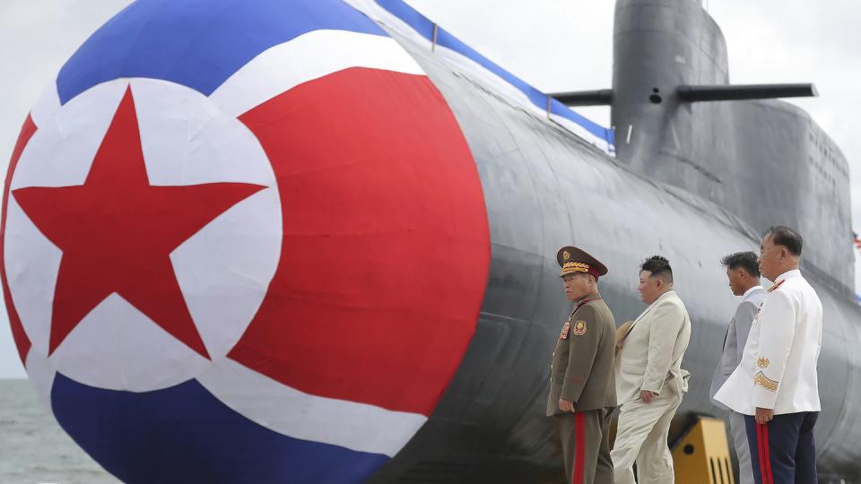 North Korea leader Kim Jong Un, second left, looks at what is said to be a new nuclear attack submarine. (Korean Central News Agency/Korea News Service via AP)