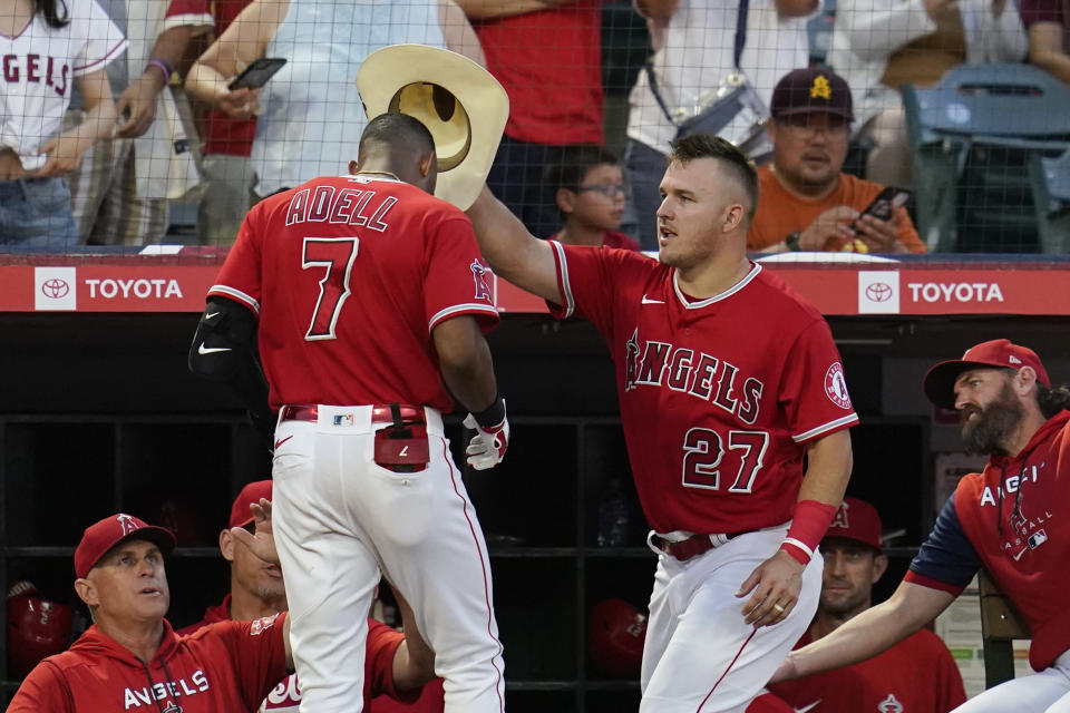 Los Angeles Angels' Mike Trout (27) places a cowboy hat on the head of Jo Adell (7) after Adell hit a home run during the second inning of a baseball game against the Detroit Tigers in Anaheim, Calif., Tuesday, Sept. 6, 2022. (AP Photo/Ashley Landis)