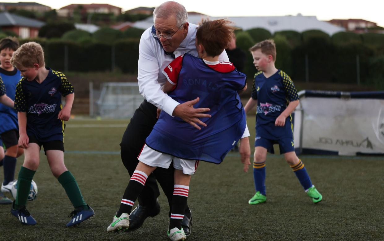 Scott Morrison channels his inner Boris Johnson as he rugby tackles a child - Asanka Ratnayake /Getty Images AsiaPac 