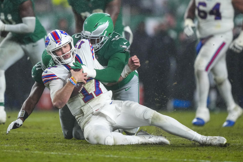 Buffalo Bills quarterback Josh Allen gets sacked by Philadelphia Eagles defensive end Brandon Graham during the first half of an NFL football game Sunday, Nov. 26, 2023, in Philadelphia. (AP Photo/Matt Rourke)