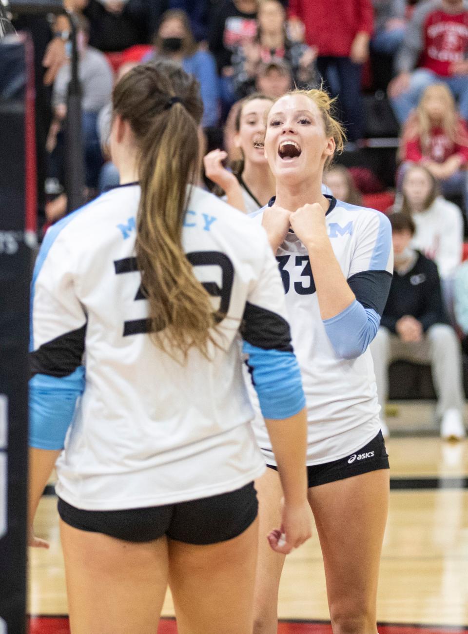 Mercy Academy players celebrate a score against Boyd County during the KHSAA State Volleyball Tournament at George Rogers Clark High School in Winchester, Ky on Friday. Nov. 5, 2021