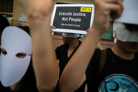 Demonstrators from Amnesty International hold placards outside the Bang Kwang Central Prison to protest against the death penalty in Bangkok, Thailand, June 19, 2018. REUTERS/Athit Perawongmetha