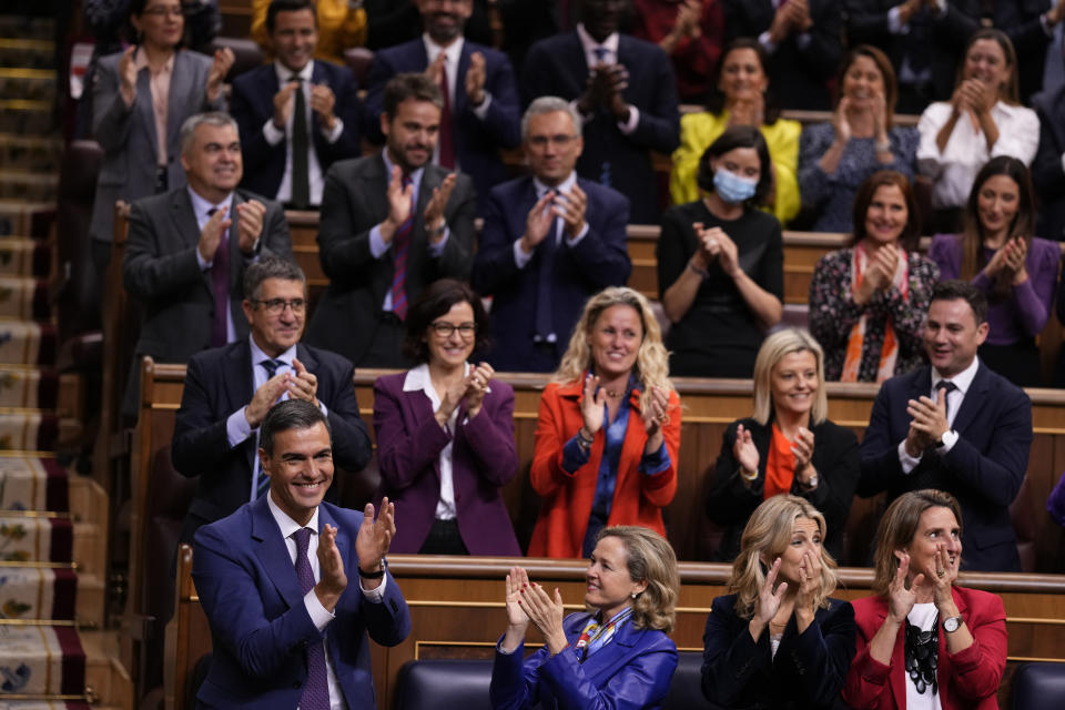 Spain's acting Prime Minister Pedro Sanchez, bottom left, applauds with socialist deputies after he was chosen by a majority of legislators to form a new government after a parliamentary vote at the Spanish Parliament in Madrid, Spain, Thursday, Nov. 16, 2023. (AP Photo/Manu Fernandez)