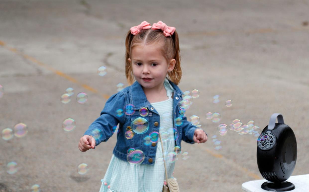 A young girl plays in bubbles during the Great Thunderbolt EGG Hunt at Cesaroni Park in Thunderbolt.