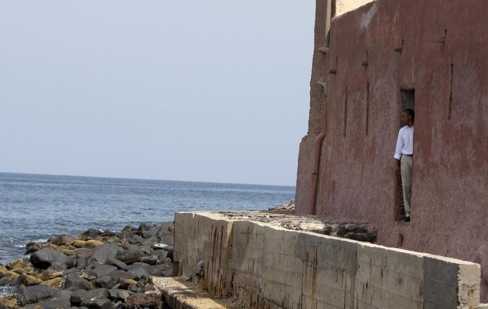 President Barack Obama looks out of the "door of no return" during a tour of Goree Island, Thursday, June 27, 2013, in Goree Island, Senegal. Goree Island is the site of the former slave house and embarkation point built by the Dutch in 1776, from which slaves were brought to the Americas. The "door of no return" was the entrance to the slave ships. (AP Photo/Evan Vucci)