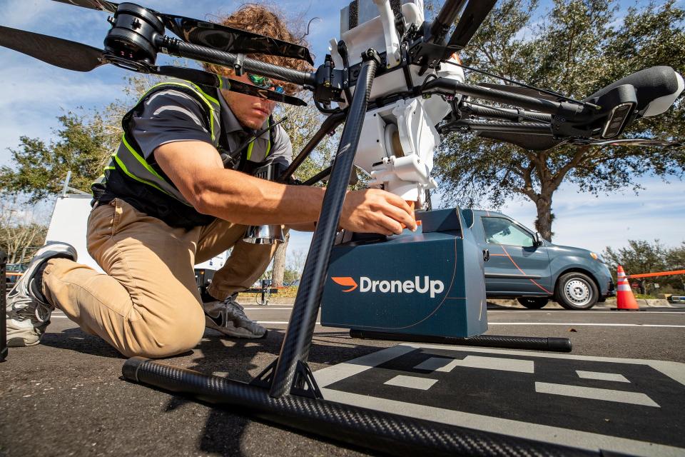 DroneUp shift lead Ryan Woodie flies a drone test flight in the parking lot of the Walmart Supercenter on Cypress Gardens Boulevard in Winter Haven Florida on January 24, 2023.