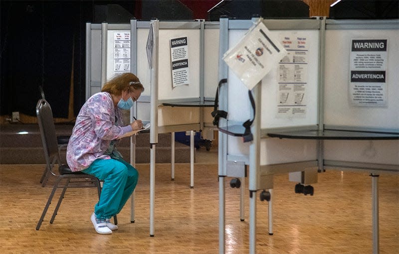 A voter fills out a ballot during early voting at a polling place at the Moose Lodge on Davis Road in Stockton on Oct. 31, 2020.