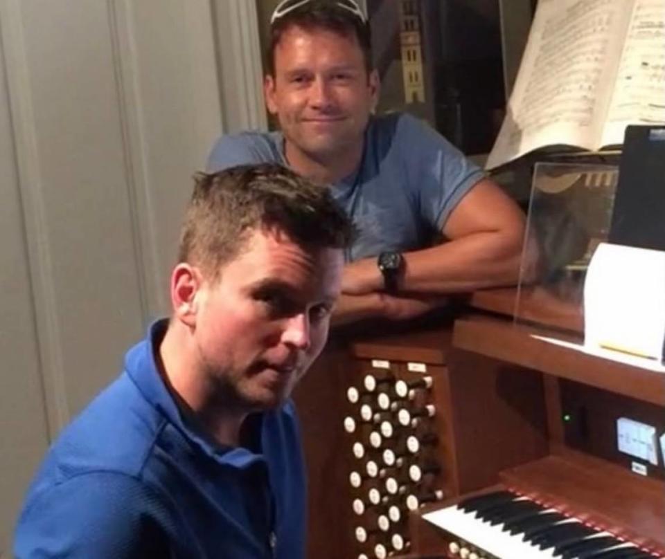 Jimmy Jones, seated at the organ, with his spouse Robert Moody. Courtesy of Robert Moody