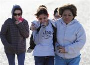 Students are reunited with families following an early morning shooting at Berrendo Middle School in Roswell, New Mexico, January 14, 2014. REUTERS/Mark Wilson/Roswell Daily Record