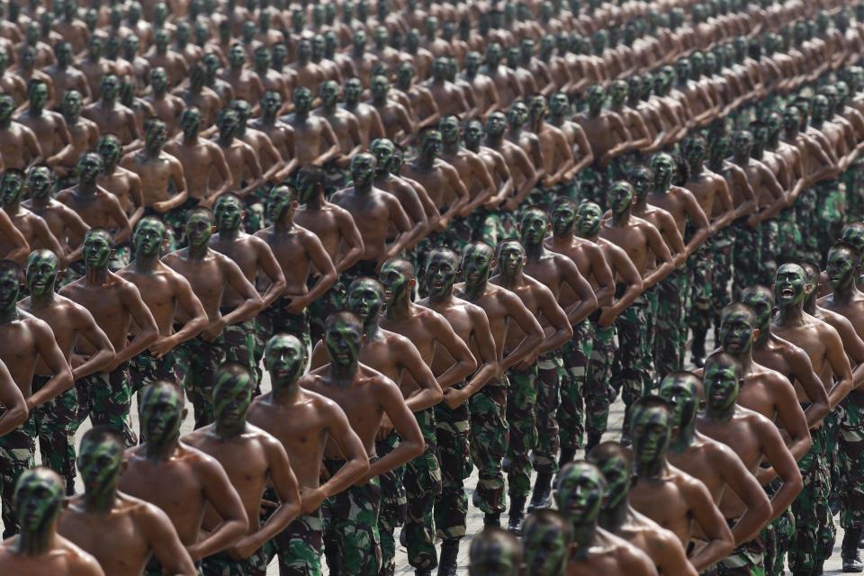 Indonesian army soldiers shout slogans as they run during a rehearsal for a ceremony marking the 70th anniversary of Indonesia's military in Cilegon, Banten province, in October 2015.