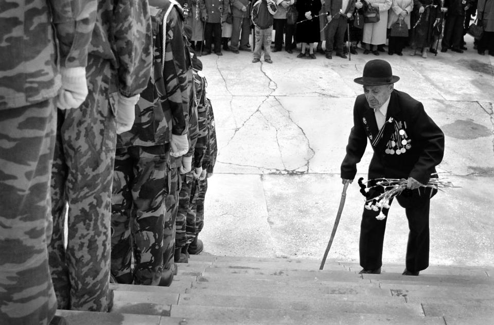 'The Last Hero' depicts a Russian war veteran climbing steps to meet current troops. It was taken by the overall Youth Winner, Sergey Kolyaskin of Russia.