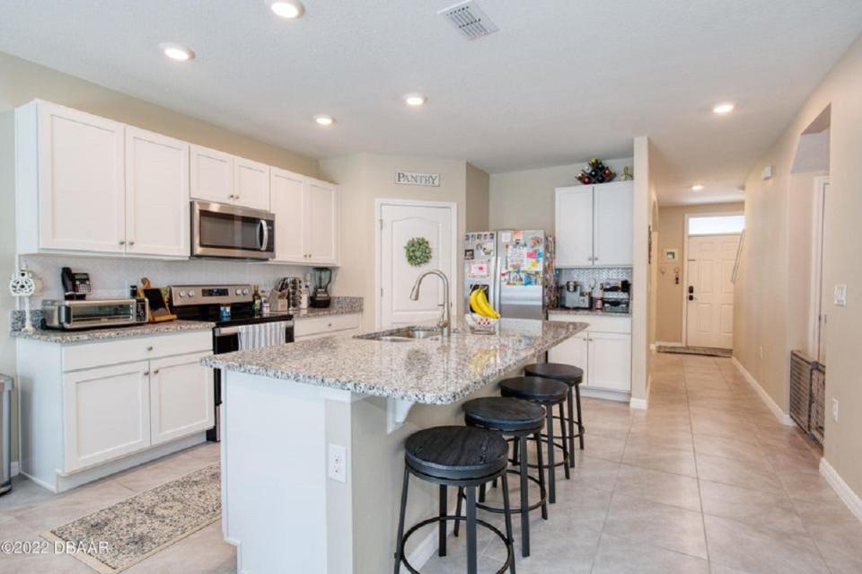 This beautiful and open chef-inspired kitchen is well equipped with granite countertops, stainless-steel appliances, a breakfast bar, walk-in pantry and breakfast nook.