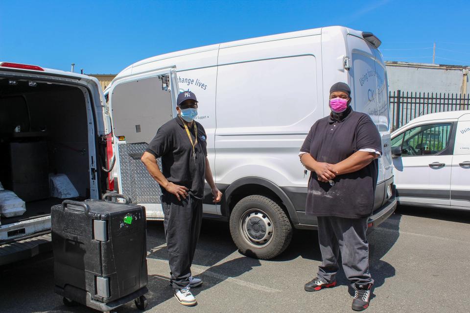 Two of Cathedral Kitchen's staff members take a break for a photo as they load a van at the Camden nonprofit. Catalytic converters were stolen from two of CK's Ford Transit trucks.