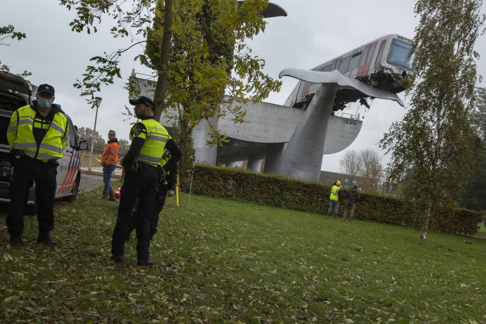 The whale's tail of a sculpture caught the front carriage of a metro train as it rammed through the end of an elevated section of rails with the driver escaping injuries in Spijkenisse, near Rotterdam, Netherlands, Monday, Nov. 2, 2020. (AP Photo/Peter Dejong)