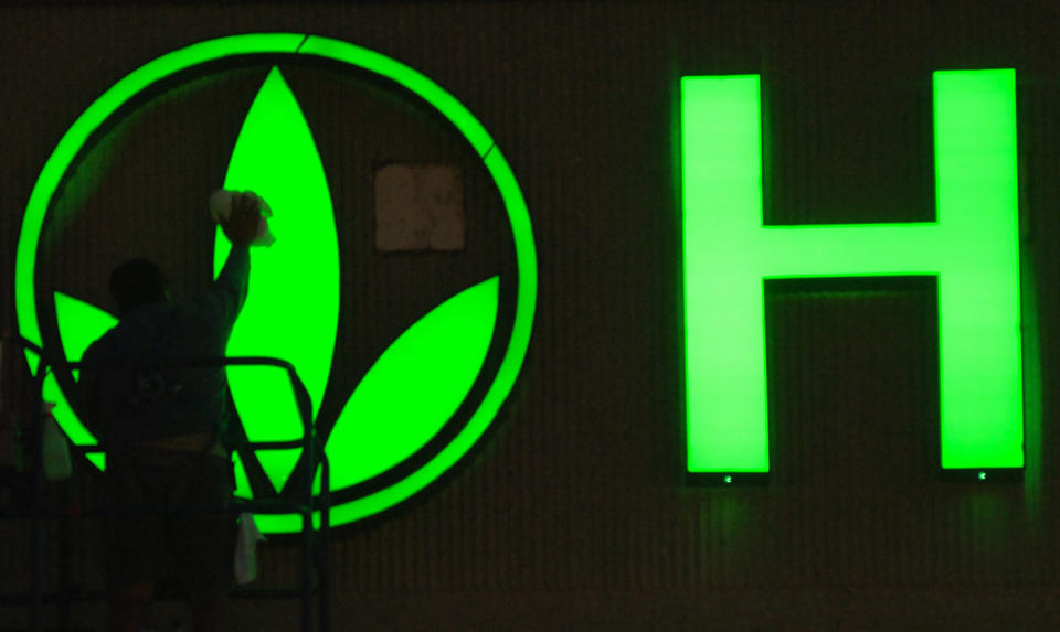 FILE - In this Friday, Sept. 8, 2006, file photo, provided by Herbalife, a worker cleans the logo on the Herbalife sign as finishing touches are put on the company's new building in Torrance, Calif. Herbalife Ltd. says that it is facing an inquiry from the Federal Trade Commission. Herbalife said that it received the civil investigative demand from the FTC on Wednesday, March 12, 2014. The FTC's website says that these are used to investigate possible "unfair or deceptive acts or practices." A representative from the FTC was not immediately available to elaborate. (AP Photo/Herbalife, Susan Goldman, File)
