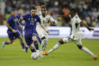 Argentina's Lionel Messi, left, and Khalifa Alhammadi of the United Arab Emirates fight for the ball during a friendly soccer match between Argentina and United Arab Emirates in Abu Dhabi, Wednesday, Nov. 16, 2022. (AP Photo/Kamran Jebreili)