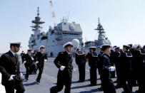 Crew members of the Japan Maritime Self-Defense Force's (JMSDF) latest Izumo-class helicopter carrier DDH-184 Kaga attend a handover ceremony for the JMSDF by Japan Marine United Corporation in Yokohama, Japan, March 22, 2017. REUTERS/Toru Hanai