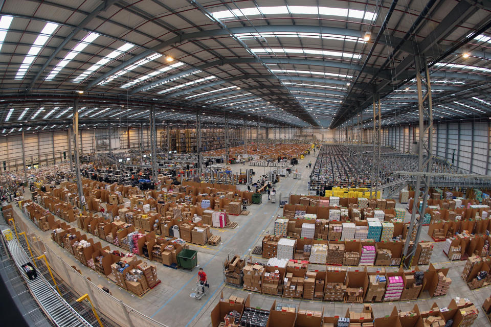 PETERBOROUGH, ENGLAND - NOVEMBER 28:  Employees select and dispatch items in the huge Amazon 'fulfilment centre' warehouse on November 28, 2013 in Peterborough, England. The online retailer is preparing for 'Cyber Monday', as it predicts the busiest day for online shopping in the UK will fall on Monday December 2nd this year. On Cyber Monday in 2012 amazon.co.uk recorded over 3.5 million individual items ordered, which equates to 41 items purchased per second. The Peterborough fulfilment centre is 500,000 sq ft, equivalent to approximately seven football pitches in floor area. Amazon are due to employ more than 1,000 seasonal staff to cope with increased demand in the run up to Christmas.  (Photo by Oli Scarff/Getty Images)