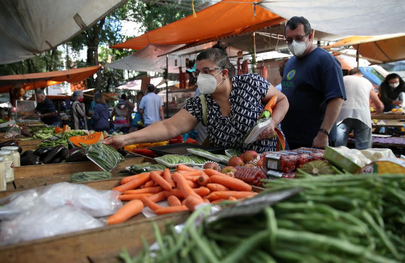 FILE PHOTO: Consumers shop at a weekly street market in Rio de Janeiro