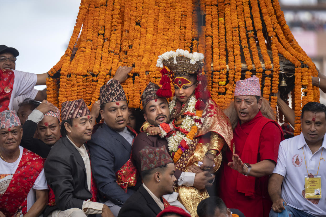 Living goddess Kumari reacts as she is being carried during Indra Jatra, a festival that marks the end of the rainy season in Kathmandu, Nepal, Tuesday, Sept. 17, 2024. (AP Photo/Niranjan Shrestha)