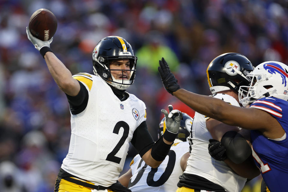 ORCHARD PARK, NEW YORK - JANUARY 15: Mason Rudolph #2 of the Pittsburgh Steelers is pressured by Ed Oliver #91 of the Buffalo Bills during the second quarter at Highmark Stadium on January 15, 2024 in Orchard Park, New York. (Photo by Sarah Stier/Getty Images)