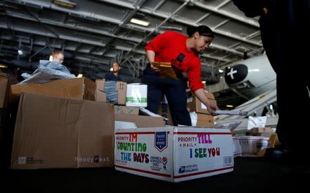 US Navy sailors sort mail in the hangar on the USS Harry S. Truman aircraft carrier in the eastern Mediterranean Sea June 15, 2016. REUTERS/Baz Ratner