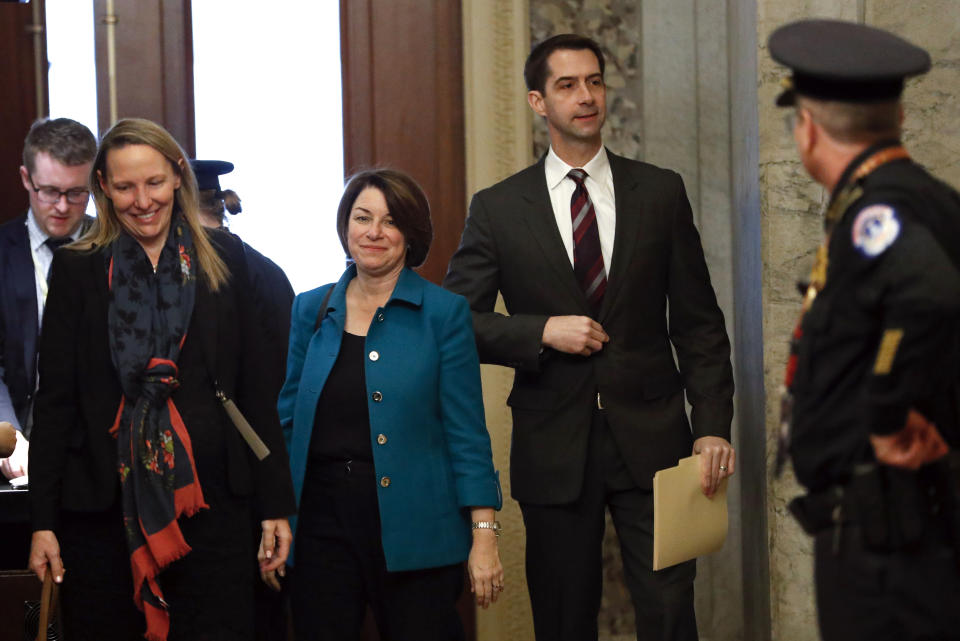 Sen. Amy Klobuchar, D-Minn., third from left, and Sen. Tom Cotton, R-Ark. forth from left, arrive at the Capitol in Washington, Tuesday, Jan. 21, 2020. President Donald Trump's impeachment trial quickly burst into a partisan fight Tuesday as proceedings began unfolding at the Capitol. Democrats objected strongly to rules proposed by the Republican leader for compressed arguments and a speedy trial. (AP Photo/Julio Cortez)
